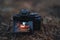 Camera on dry grass shooting a Halloween pumpkin with a scary face and a candle in it