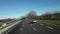 The camera flies over a car suburban highway