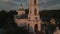The camera flies over the evening Orthodox church with a bell tower. The village of Rakhmanovo,