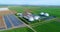 Camera flight over biogas plant from pig farm. Renewable energy from biomass. Modern agriculture European Union