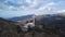 Camera is flying around large memorial cross on peak of mount