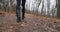 Camera following woman legs while walking in forest slow motion