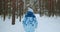 The camera follows an elderly female skier in a blue suit