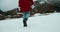 Camera follows woman on hike journey walk on snow in boots