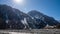 camera Hyperlapse Clouds move over green foothills on edge of small city on sunny day time,Shadow clouds over mountains