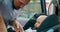 Camera inside the car Closeup baby boy sits in the baby car seat inside of car Young bearded father fastens seat belts