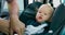 Camera inside the car Closeup baby car seat Baby boy is carried on hands of his father who puts baby inside the baby car