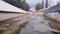 Camera motion above the dirty city river surrounded by a stone embankment