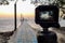 Camera mounted on a tripod photograph the pier and sunrise, Focus on screen