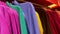Camera movement along a row of huge numbers of colorful women jumpers and sweaters on hangers. The concept of shopping, black Frid
