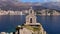 Camera moves away from Sveta Nedjelja chapel located on islet of same name in the sea, old town of Petrovac among