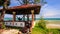 Camera Moves by Red Pavilion with Girl in Hammock to Azure Sea