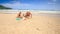 Camera Moves to Grandpa Kids Play among Sand Heap on Beach