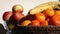 Camera pan, fresh fruit, mandarin oranges, apples, bananas in glass and wicker bowl, detail