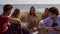 Camera pan on group of friends at the beach