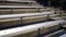 Camera pans over empty bleachers at a sporting event at night