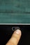 Camera Privacy Cover Slide by a finger with a green wooden wall