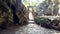 Camera removes from stone arch shows rocky walls in park