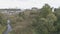 The camera rises over a small river and the temple becomes visible.