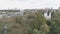 The camera rises over a small river and the temple becomes visible.