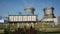 Camera Shows Oil Reservoirs at Refinery Plant against Blue Sky