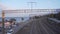 Camera slowly moving showing old metallic bridge over railways on sunny day.