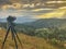 Camera and stand take time lapse on top of mountain and light ray