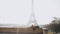 Camera tilts down on Paris Eiffel Tower view and relaxed happy male tourist lying down using smartphone slow motion.