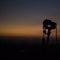 Camera on a tripod with golden horizon at dusk