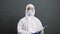 Camera zooming on doctor in protective suit who fights with coronavirus epidemic