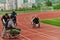 A cameraman filming the participants of the Paralympic race on the marathon course