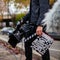 Cameraman holding a professional movie camera and a clapper board ready to record in the street