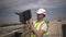 Cameraman opens casing of camera standing on building roof