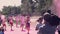 The cameraman and photographer take pictures, as the organizers throw, throw holi, pink, colored paint on the face of
