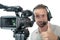 Cameraman with professional camcorder and headphone isolated on