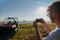 cameraman recording a young couple enjoying a buggy car ride up a mountain