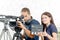 A cameraman and a young woman with a movie camera and clapper