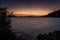 Cameron Lake on Vancouver Island, Canada at sunset, the sky glowing pinks and purples as the wind creates ripples on the lake