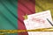 Cameroon flag and Health insurance claim form with covid-19 stamp. Coronavirus or 2019-nCov virus concept