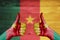 Cameroon flag painted on female hands thumbs up