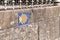 Camino de Santiago sign tile on stone wall. Way of St. James way shell