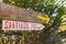 Camino de Santiago sign with yellow arrow. Wooden board with distance to Santiago de Compostela. Pilgrimage concept.