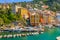 Camogli Marina aerial view. Boats and yachts moored in harbor with green water. A lot fo colorful buildings