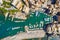 Camogli Marina aerial view. Boats and yachts moored in harbor with green water. A lot fo colorful buildings