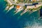 Camogli rocky coast aerial view. Boats and yachts moored near harbor with green water