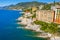 Camogli rocky coast aerial view. View from harbor with green water