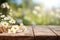 Camomile flowers on rustic wooden table in the morning, close up shot with blurred nature background. Generative AI