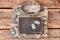 Camouflage army clothes, book, and dog tags on wood.