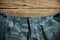 Camouflage pattern pants on wooden background