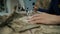 camouflaged military clothes. sewing. close-up. seamstress sews fabric items, military uniform on sewing machine in